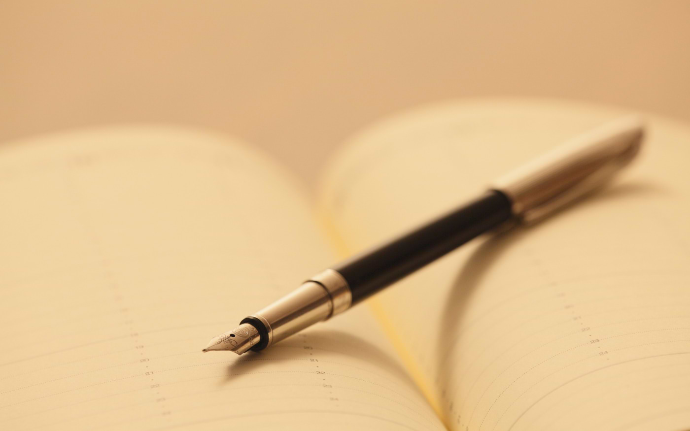 Fountain pen resting on an open notebook page