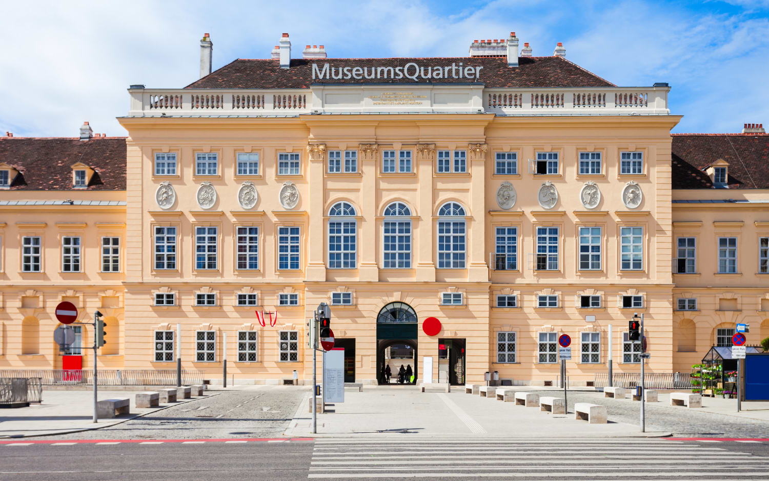 MuseumsQuartier Vienna main entrance, pastel Baroque facade of the former imperial stables with arched gateway