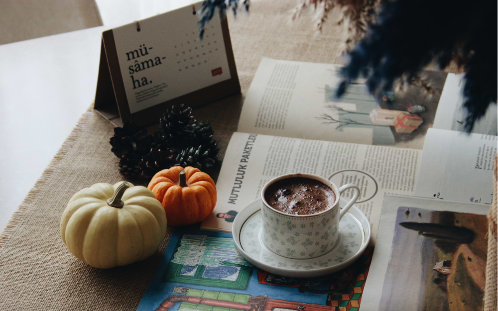 Close-up of a steaming cup of rich hot chocolate, served on a marble table in a cozy Parisian café