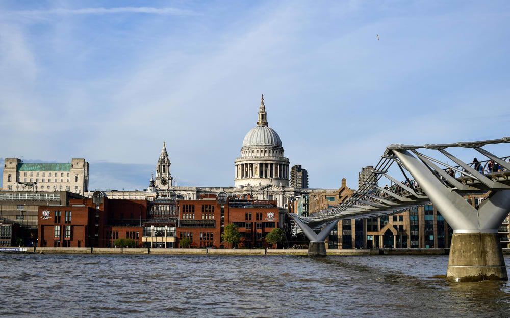 St Paul's Cathedral and Millennium Bridge viewed across the Thames, London