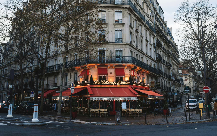 Hostoric streets of Montmartre with baroque buildings and a cafe