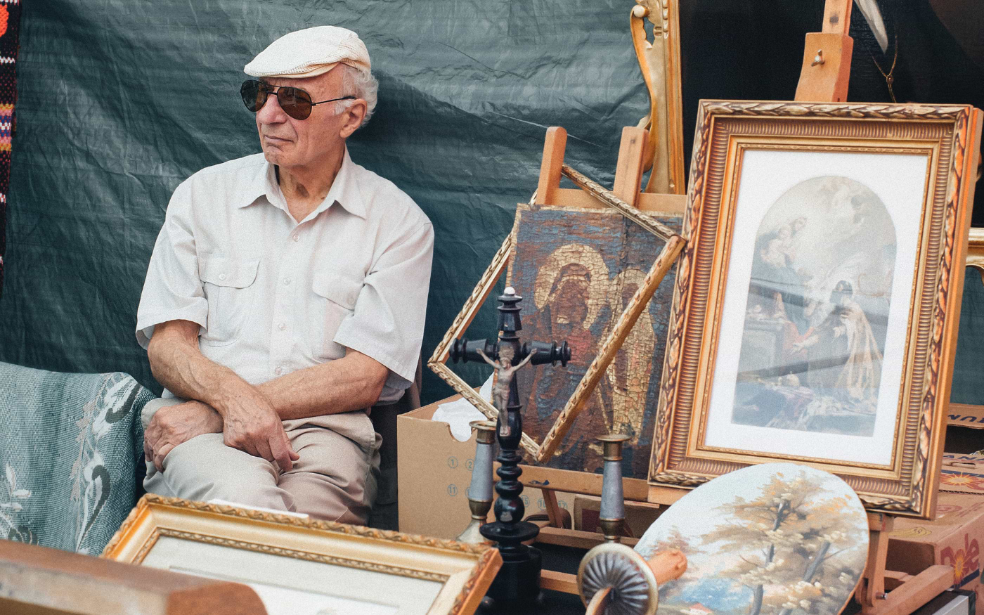 A seller sitting at a flea market stall in Vienna, Austria
