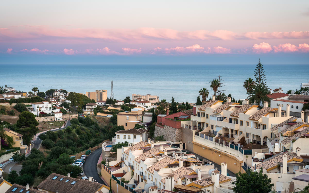 Panoramic view of Fuengirola rooftops and the Mediterranean Sea at dusk, Costa del Sol, Spain