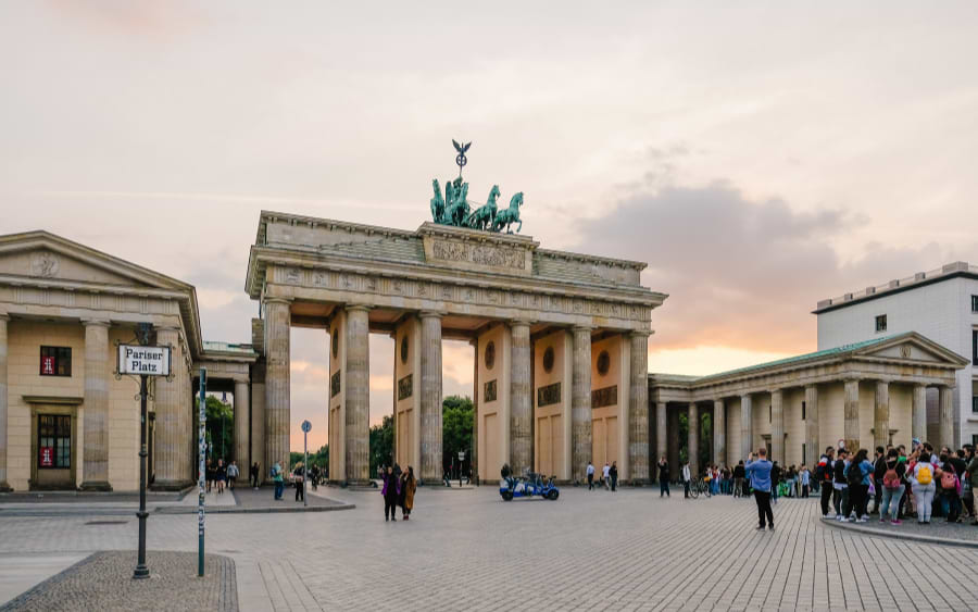 Take a walking tour and visit the Brandenburg Gate, learning about its historical significance.