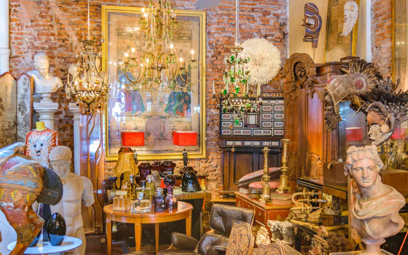 A Parisian antique shop showcasing vintage jewelry, art, unique furniture and decor pieces.