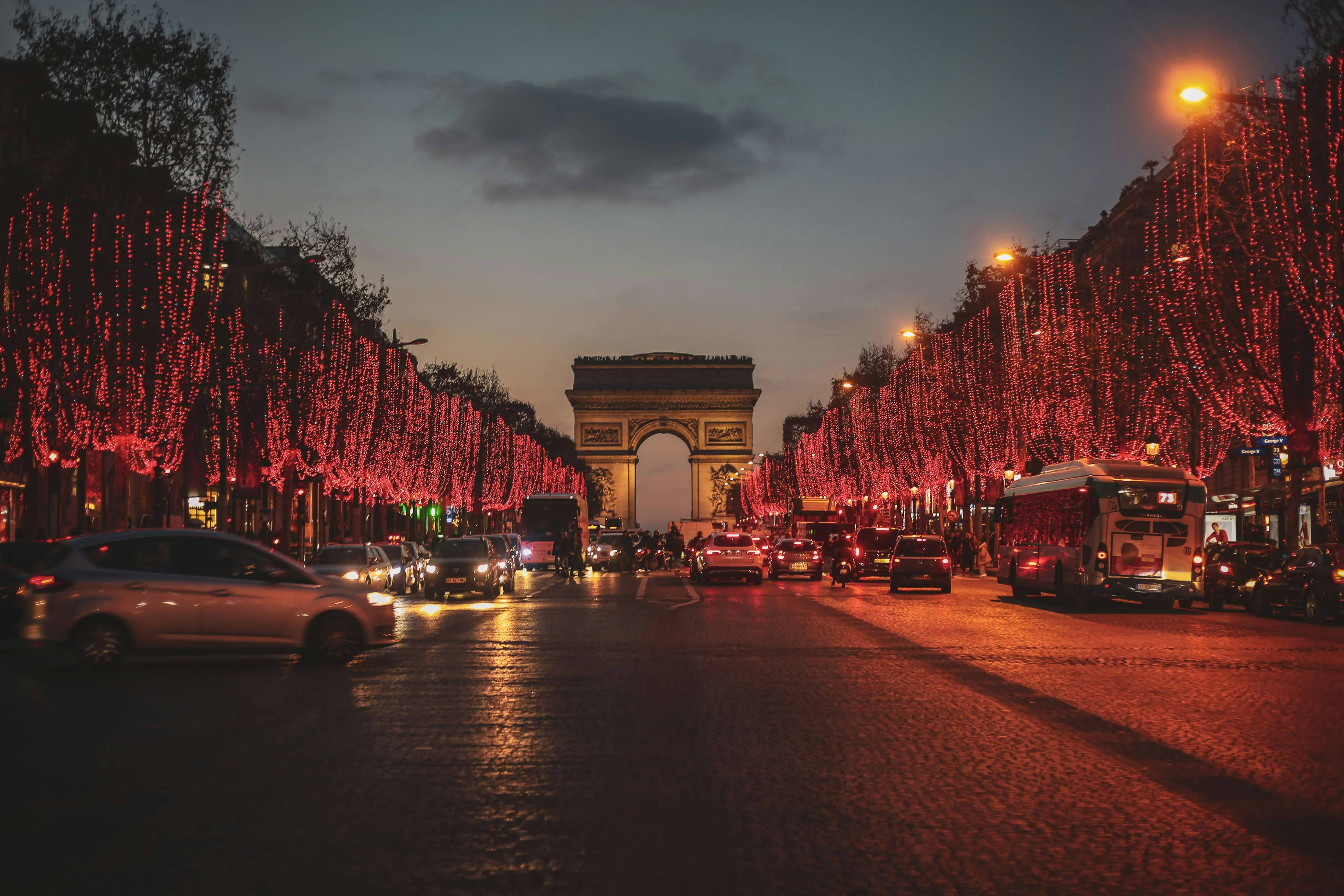 The bustling Champs-Élysées avenue adorned with festive holiday lights