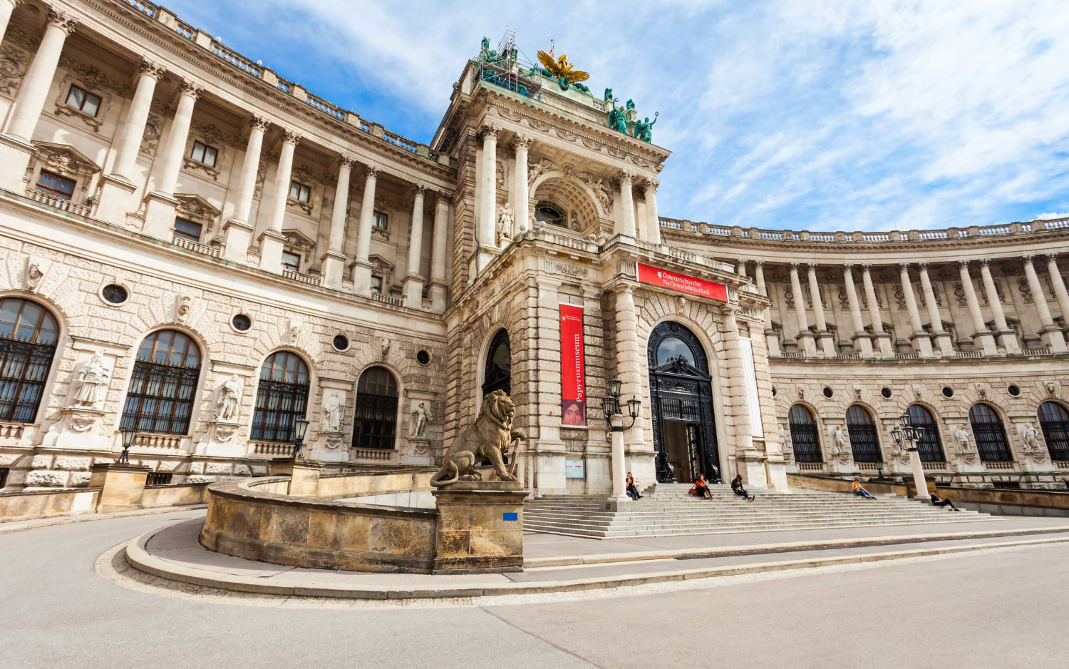 Neue Burg wing of the Hofburg in Vienna, entrance to the Austrian National Library with a stone lion statue