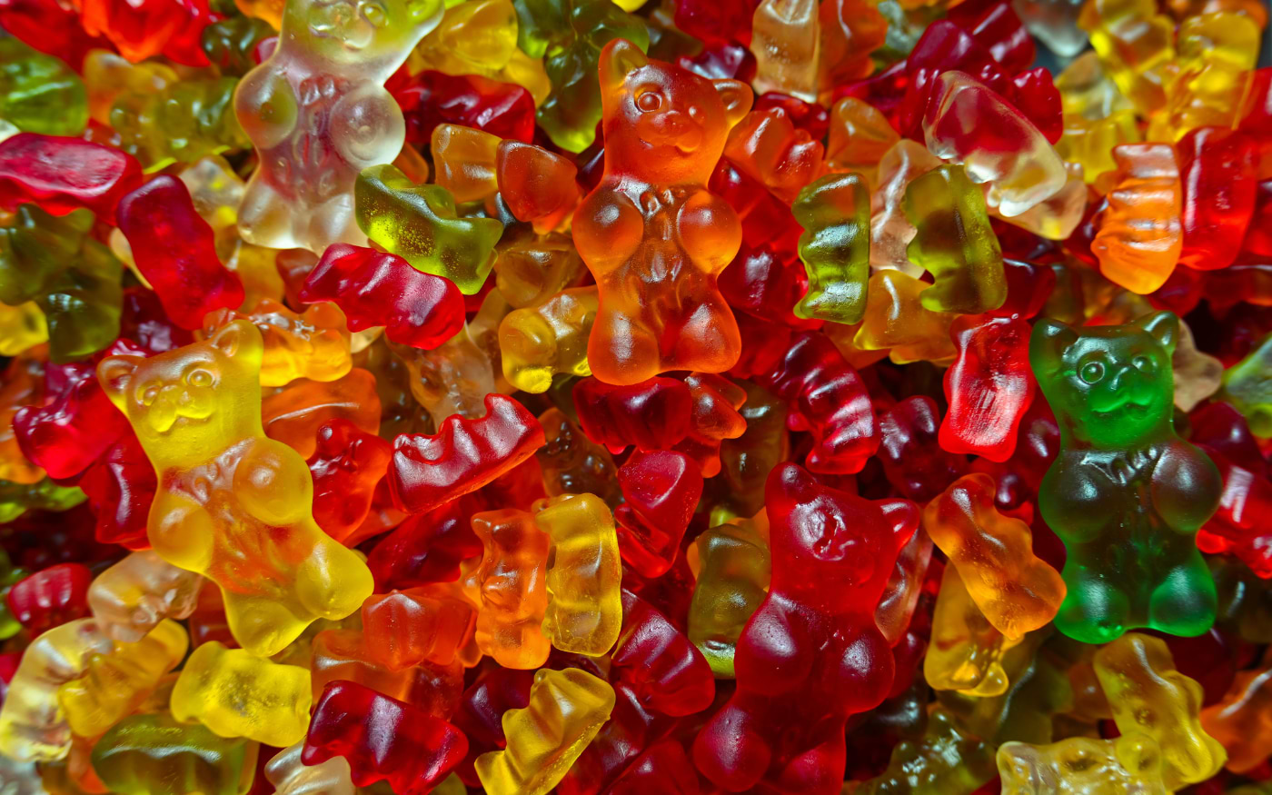 Close-up of colourful Haribo-style gummy bears in red, yellow, orange and green