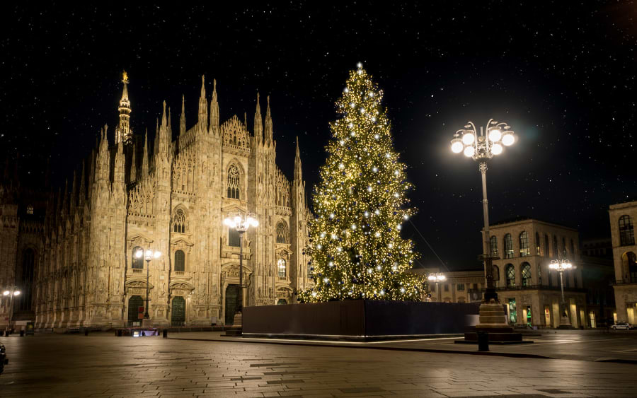 PIazza Duomo at night, illuminated by festive lights.