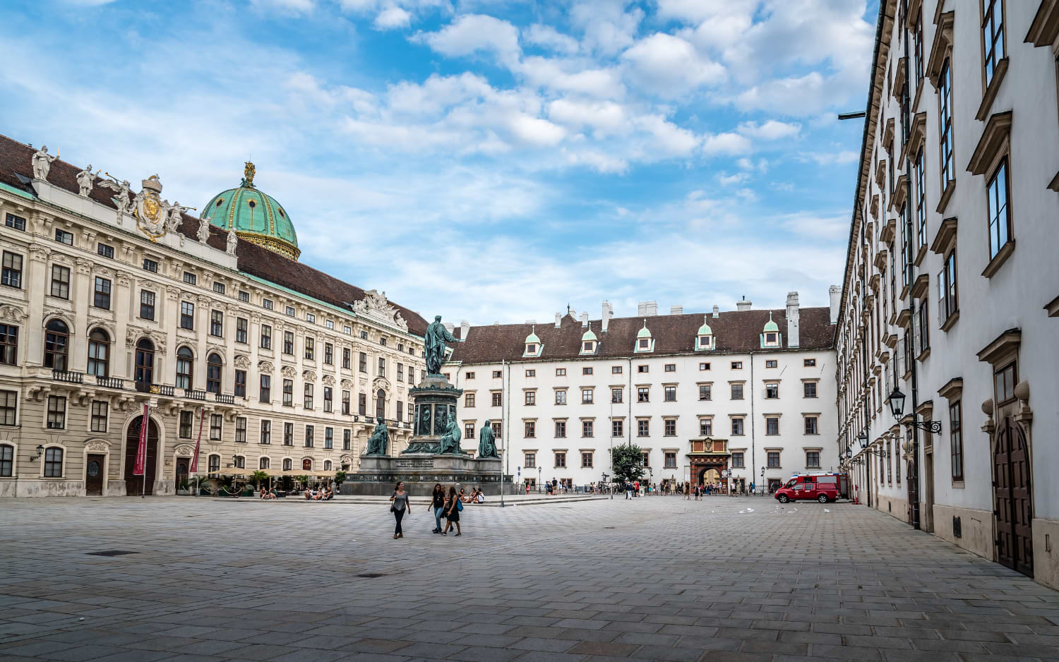 Hofburg courtyard In der Burg in Vienna with the Emperor Franz monument, a green dome and the red Swiss Gate