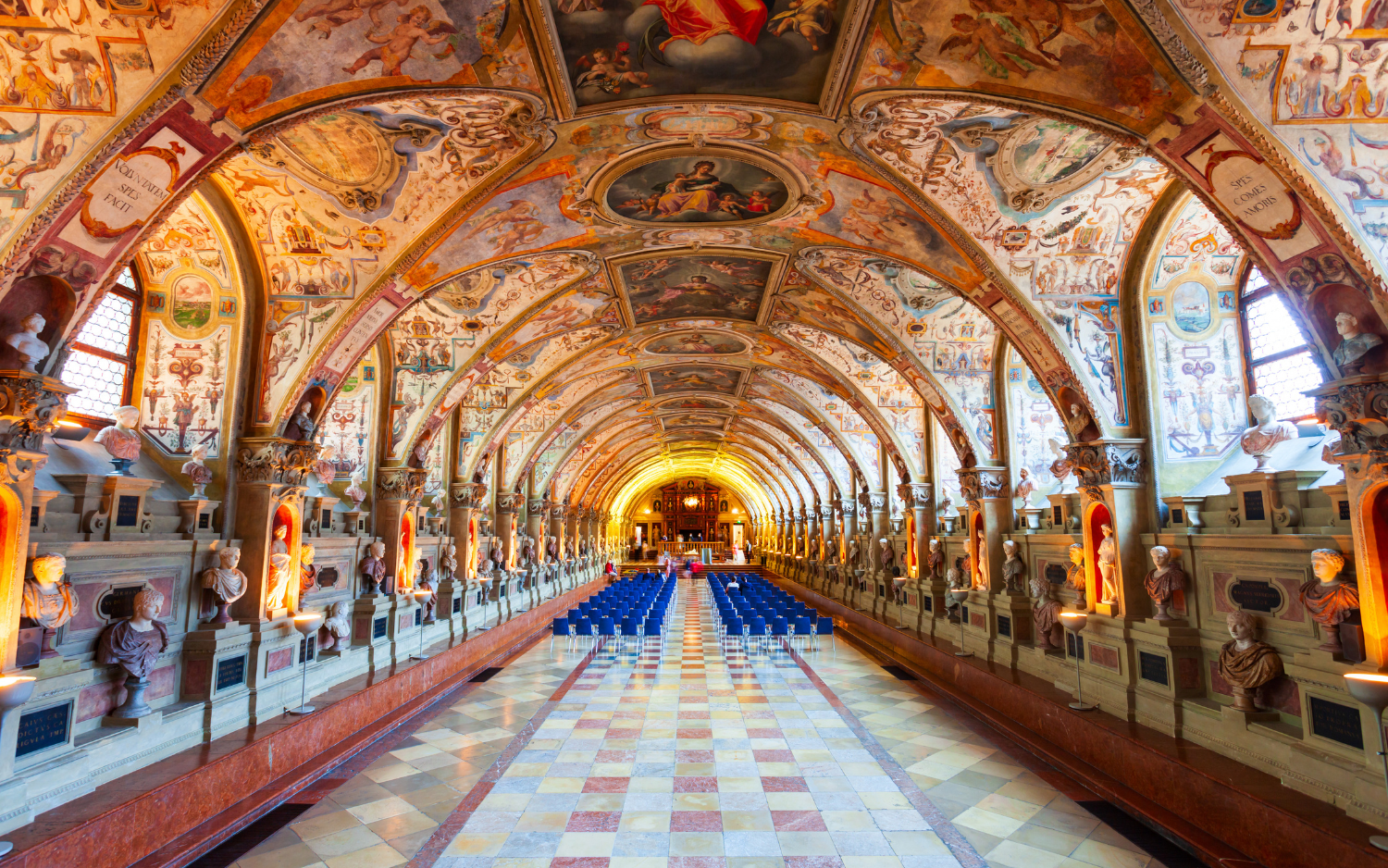 The Antiquarium hall inside Munich's Residenz Museum, a long vaulted gallery lined with ancient busts and richly painted ceilings.