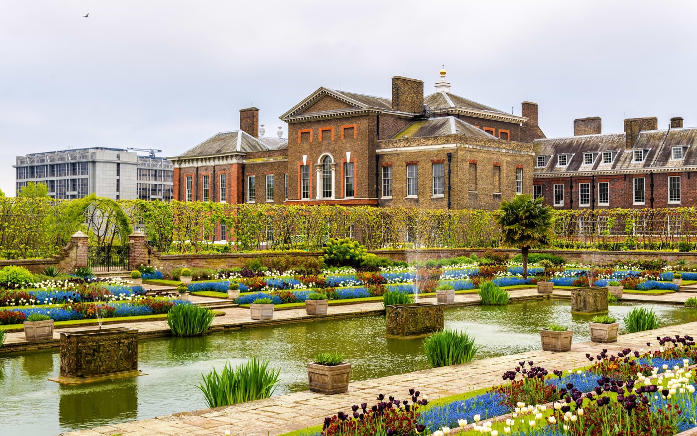 Sunken Garden at Kensington Palace with a rectangular pond, red and white tulips and blue forget-me-nots in spring