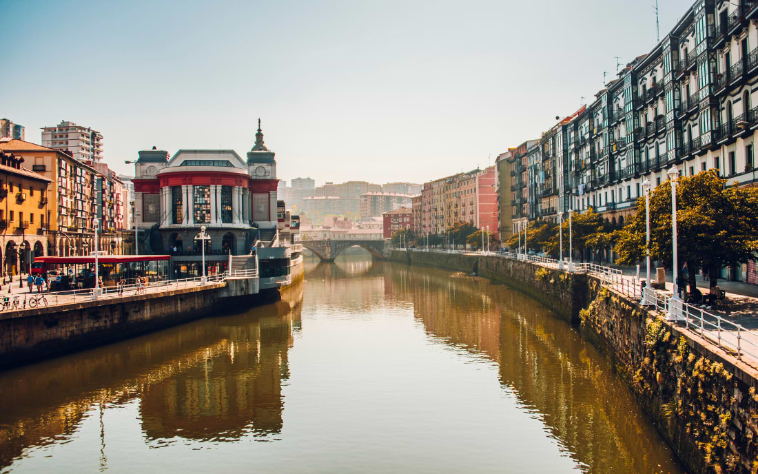 Mercado de la Ribera on the banks of the Nervión River in Bilbao bathed in warm morning light