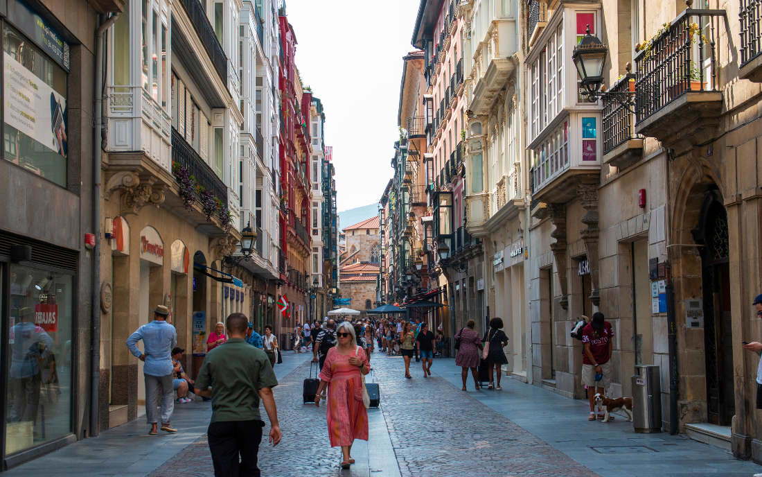 Busy pedestrian street in the Casco Viejo old quarter of Bilbao with historic buildings and visitors