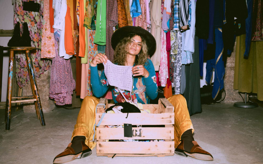 Shopper browsing vintage clothing at an Amsterdam vintage market