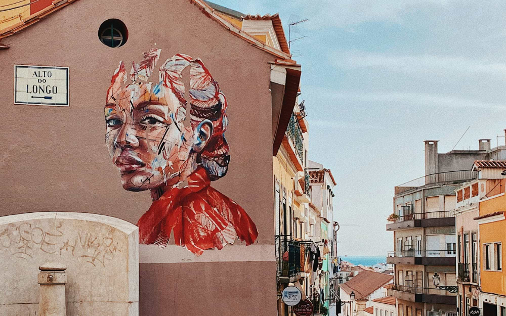 Street art mural in the Mouraria district, Lisbon, Portugal.