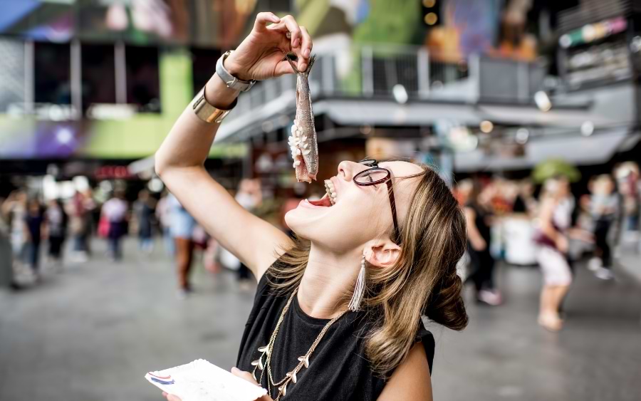 A woman enjoying a snack at Rotterdam Markthal