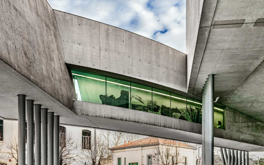 The contemporary architectural design of the MAXXI Museum, featuring flowing lines and dynamic spaces, designed by Zaha Hadid.