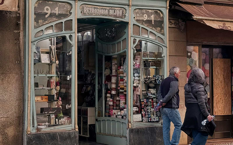 Historic Art Nouveau haberdashery shop Retrozaria Bijou in Portugal, with colorful yarns and sewing supplies displayed.