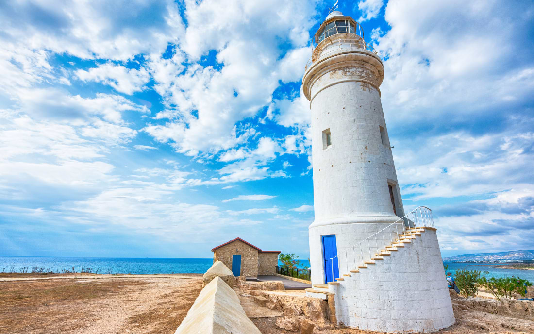 Paphos lighthouse on a sunny day with blue sky and sea views, Cyprus